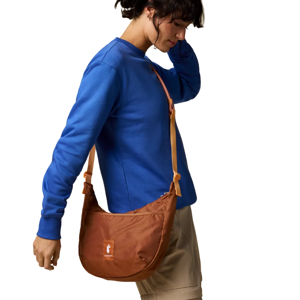 Cotopaxi Whiskey Trozo bag worn crossbody in casual setting