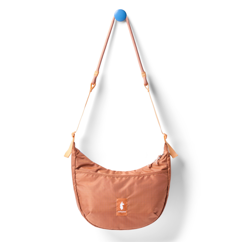 Cotopaxi compact shoulder bag with external accessory pocket