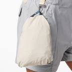 Packable pant legs stored in cargo pocket stuff sacks