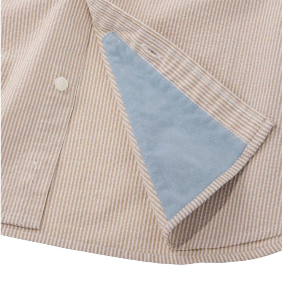 Close-up of khaki stripe seersucker fabric on LL Bean performance shirt hem