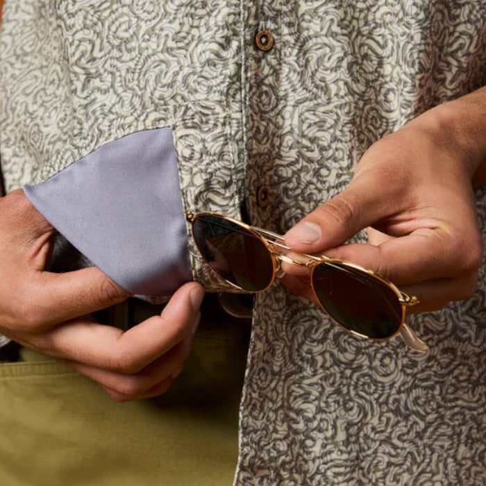 Built-in microfiber sunglass-cleaning cloth detail on the hem of the Cotopaxi Afuera Button Up Shirt