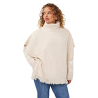 EsQualo Knit Turtleneck Poncho in Biscuit front view with ribbed turtleneck, side buttons and fringe hem