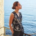 Woman wearing the Esqualo Wrap Over Flower Top in Black styled with casual chic bottoms for an effortless everyday look