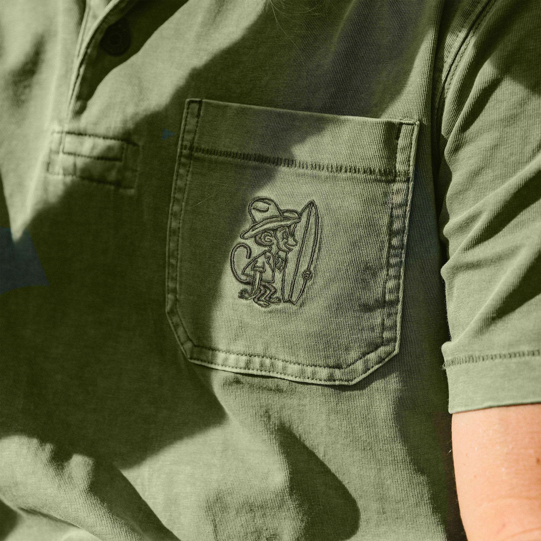 Howler Bros Pilgrimage Polo chest pocket detail with El Monito embroidery
