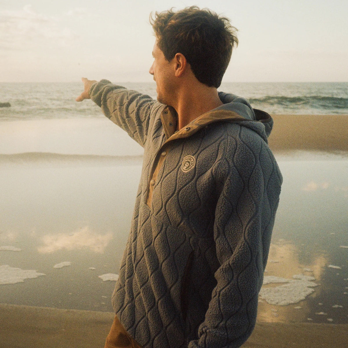 Model wearing Howler Brothers Chisos Hooded Pullover in Capillary Waves Stormy Sea