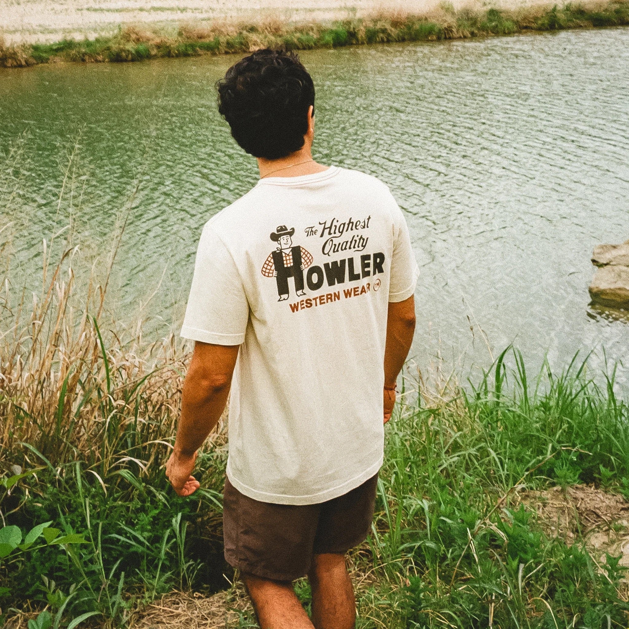 Person wearing the Howler Brothers Western Wear Cotton Tee in Natural outdoors