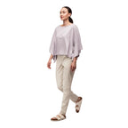 Side view of the Indyeva Nuvem Short Sleeve Top in Haze highlighting the draped fit, boat neckline, and comfortable everyday styling.