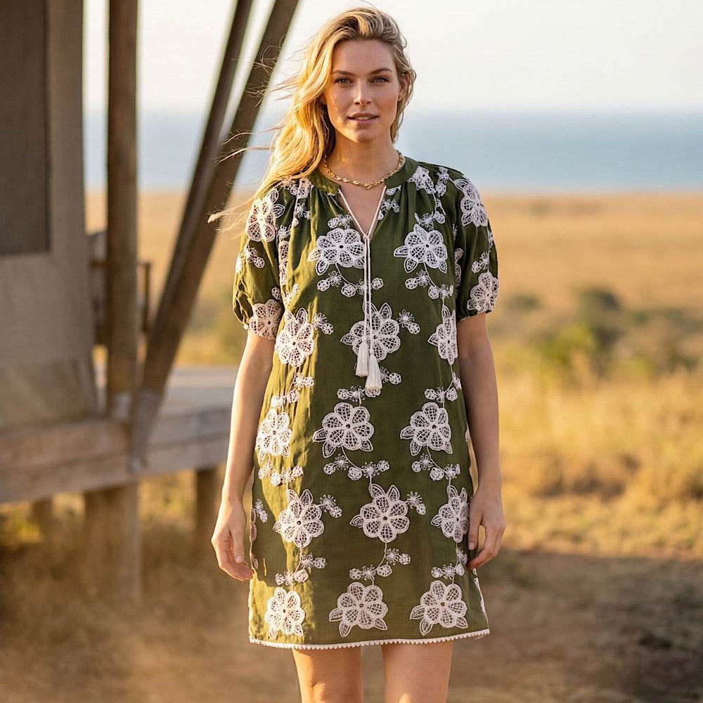 Model wearing Karen Kane Puff Sleeve Tassel Dress in olive and natural