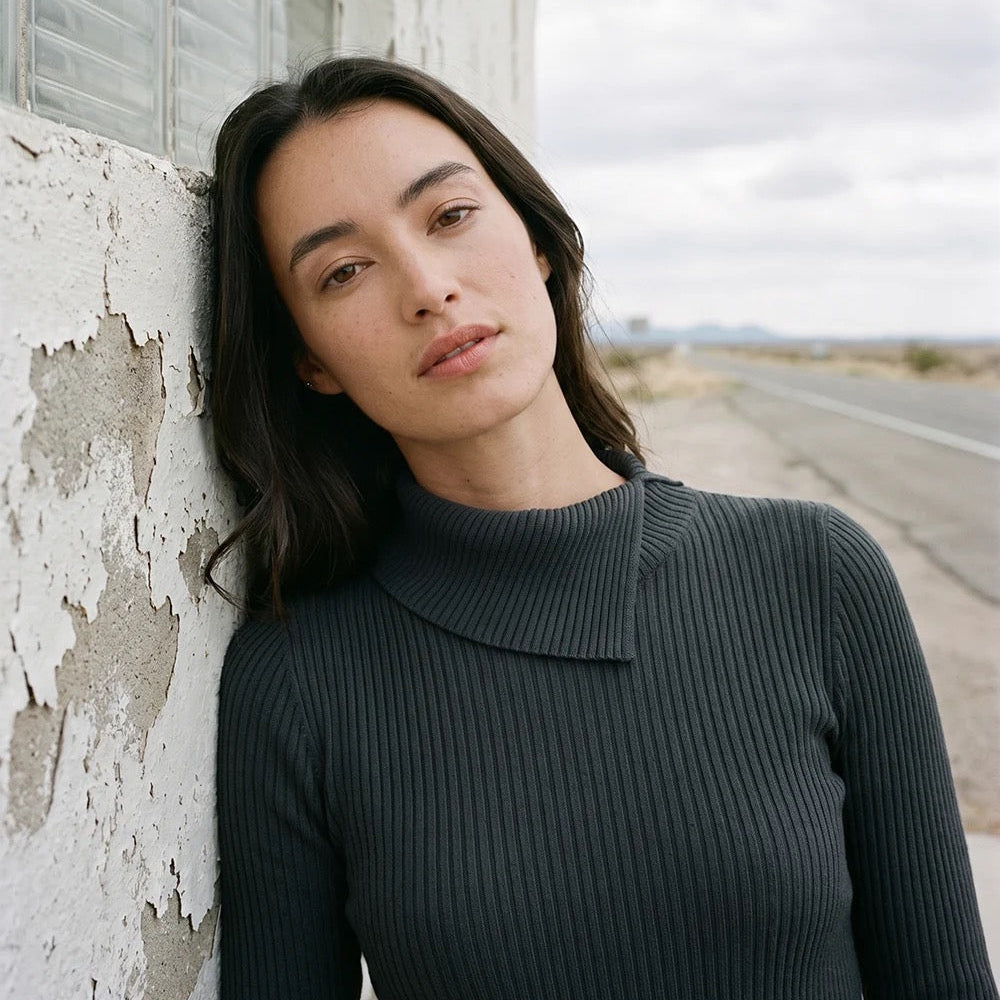 Model wearing Karen Kane Wide Ribbed Long Sleeve Split Neck Top in black