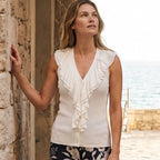 Woman wearing the Karen Kane Sleeveless Ruffle V-Neck Sweater in Off White