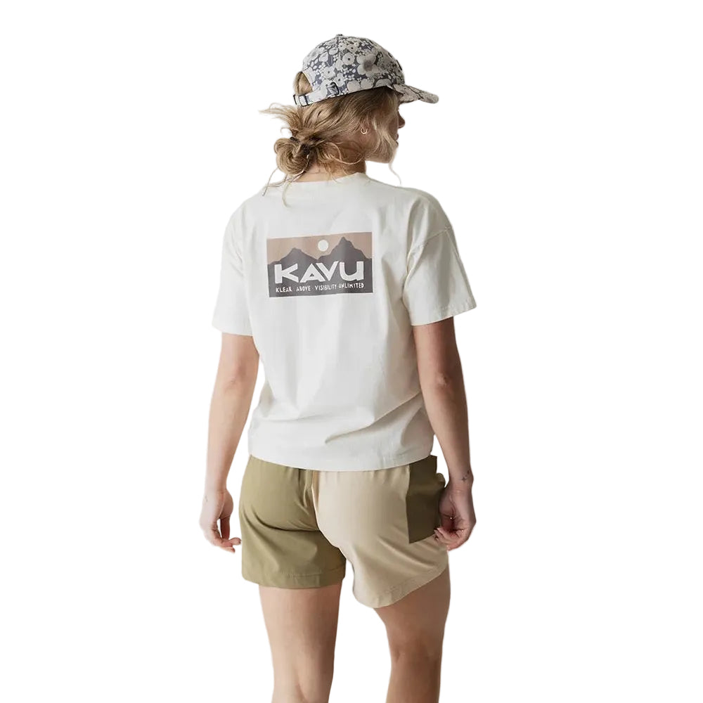 Full-body view of a woman wearing the KAVU Leilani Short in Daisy Love for summer travel, casual outings, and warm-weather adventures