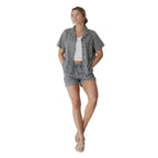 Full-body view of a woman wearing the KAVU Nosara Short in Vintage Motif for summer travel, casual outings, and outdoor adventures