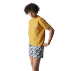 Full-body view of a woman wearing the KAVU Salt Beach Short Sleeve Tee in Wood Thrush for everyday comfort and outdoor adventures