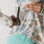 Close-up of the KAVU Sunshade Hoody in Mod Mix highlighting the honeycomb mesh knit fabric and colorful digital print