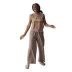 Full-body view of a woman wearing the KAVU Tamarindo Pant in Chocolate for travel, outdoor adventures, and everyday comfort