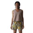 Full-body view of a woman wearing the KAVU Vacay Tank Top in Chocolate for travel, casual outings, and warm-weather adventures
