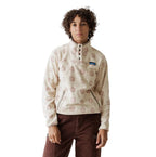 Full-length front view of woman wearing KAVU Women's Cavanaugh Fleece Pullover in Snow Floral