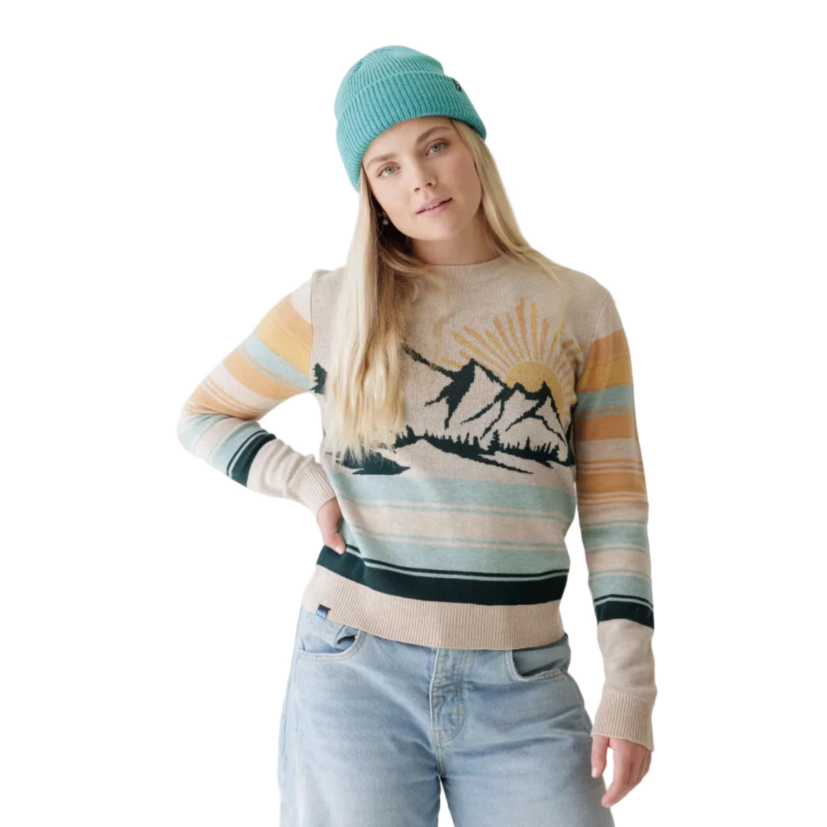 Woman wearing KAVU Women's Hillrose Sweater in Winter Valley front view with mountain and sunrise jacquard design