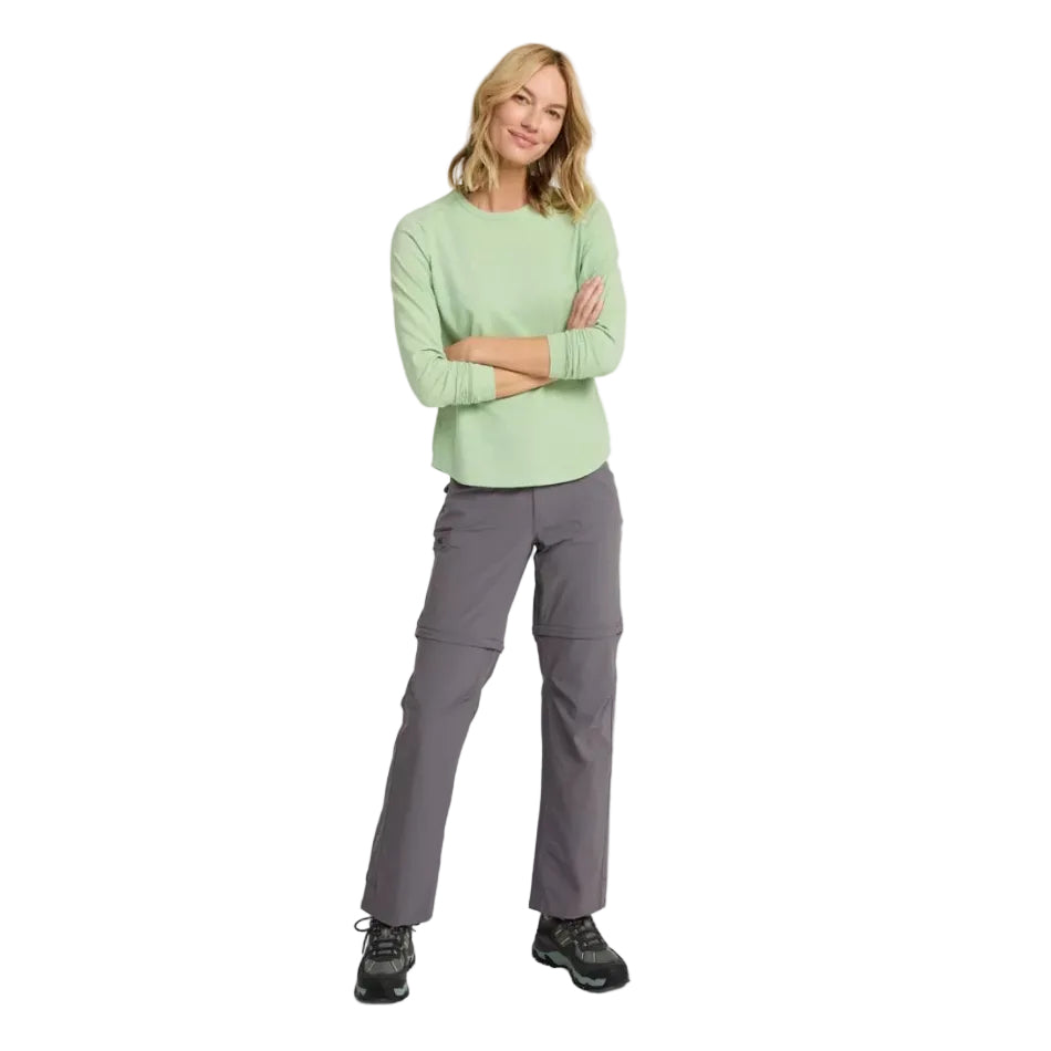 Woman wearing No Fly Zone Zip-Off Pants in Dark Silt on a hiking trail