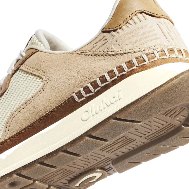 Detail view of the mesh and full-grain leather accents on the OluKai women’s Koke sneaker in White Sand/Sand