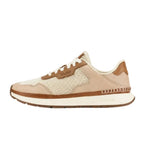 Side view of OluKai women’s Koke sneaker in White Sand/Sand with breathable mesh and leather accents
