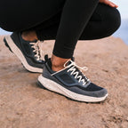 Women’s OluKai Makiki Shoe in Lava Rock/Dark Shadow worn for all-terrain adventures and everyday comfort