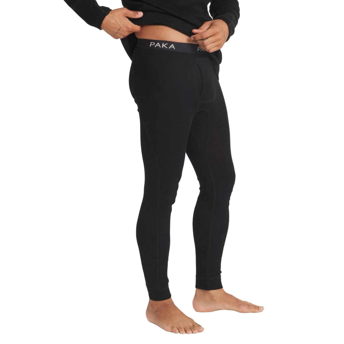PAKA Men's Thermal Bottoms in Black showing rib-knit fabric and waistband detail