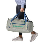 Patagonia Black Hole Duffel 55L in Birch White carried by model