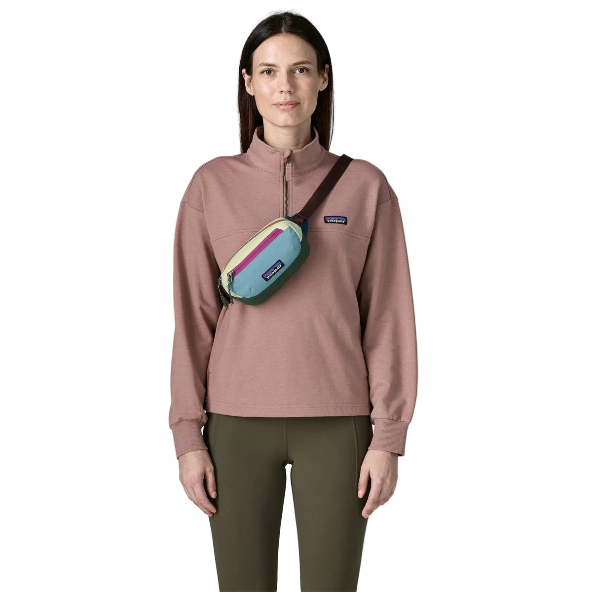 Patagonia Terravia Mini Hip Pack 1L in Berry Fig cross over on model