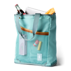 Cotopaxi Todo tote mesh side pockets holding chapstick and showing laptop sleeve