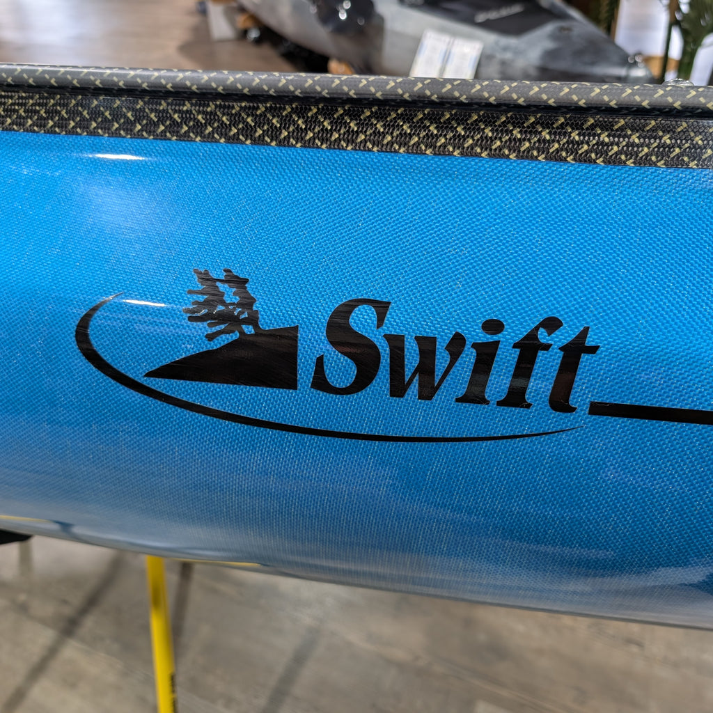 Blue kayak with 'Swift' logo on a blurred background