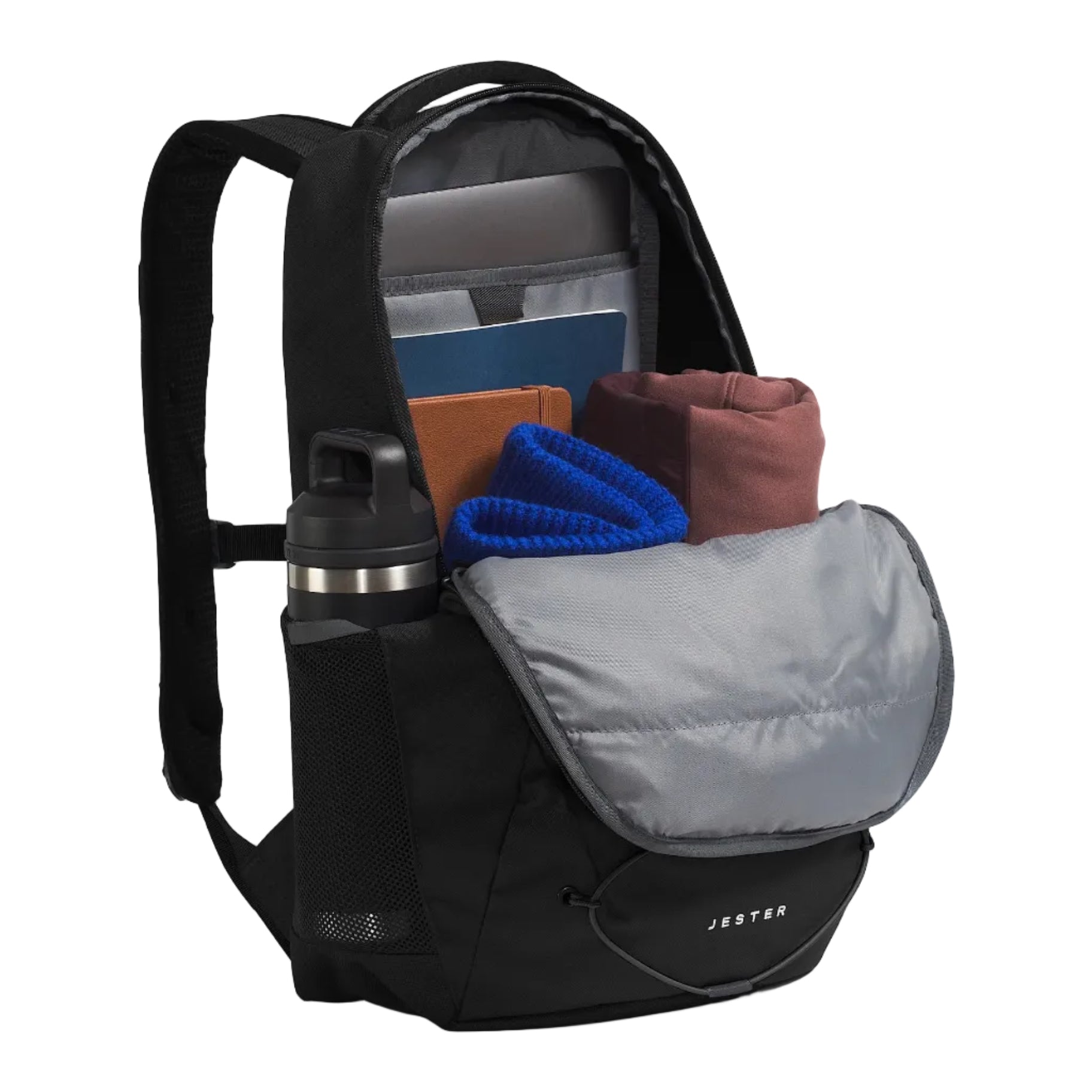 A black Jester backpack shown open, revealing its interior compartments and a front pocket with a gray flap. I